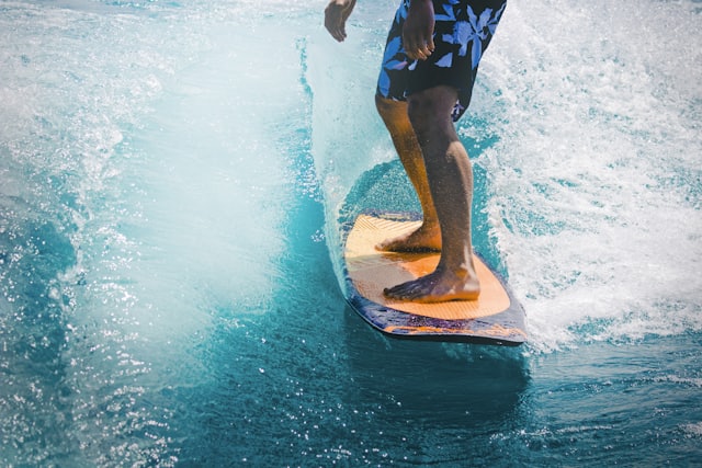 A surfer riding a wave in clear water